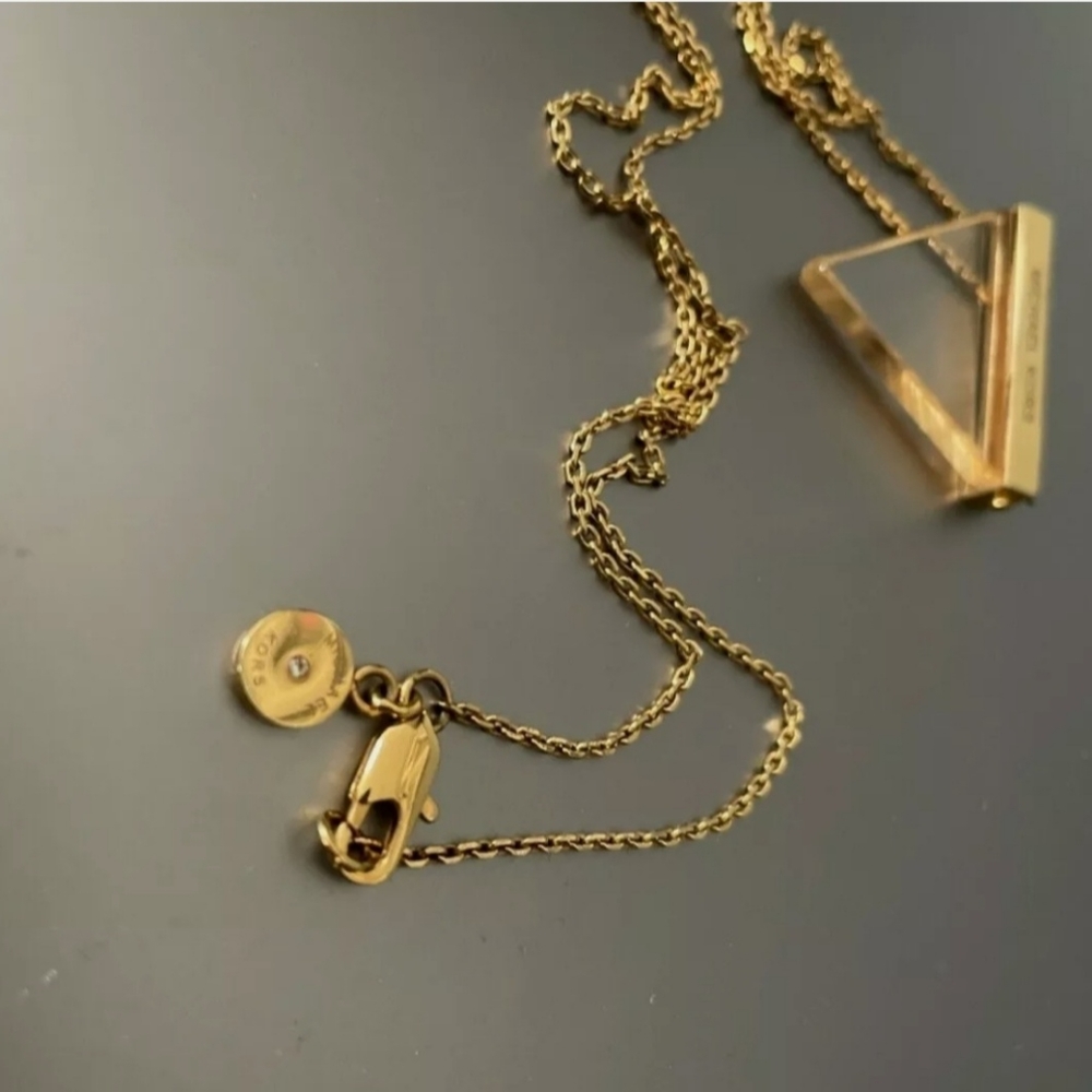 100% Authentic Michael Kors Goldtone necklace w/ clear triangle pendant